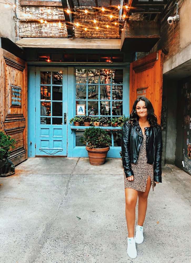 A photo of a female Googler in front of a restaurant