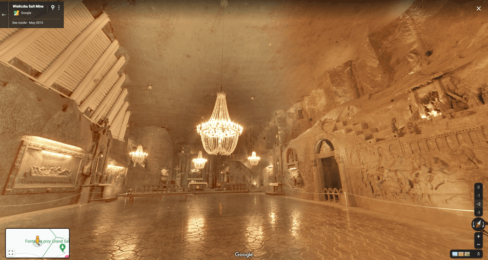 Street View image of an empty chamber with a large chandelier